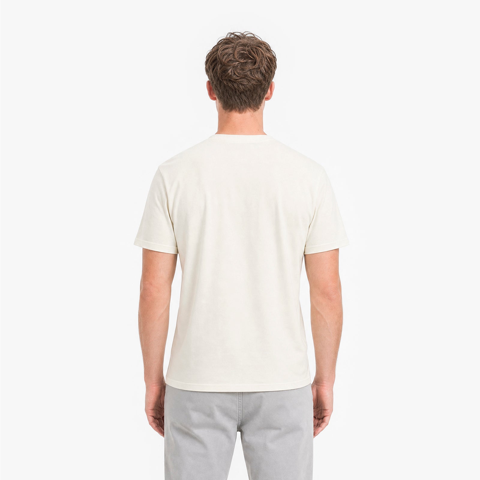 Man wearing a plain white t-shirt on a white background