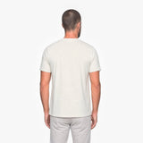Man wearing a plain white t-shirt on a white background