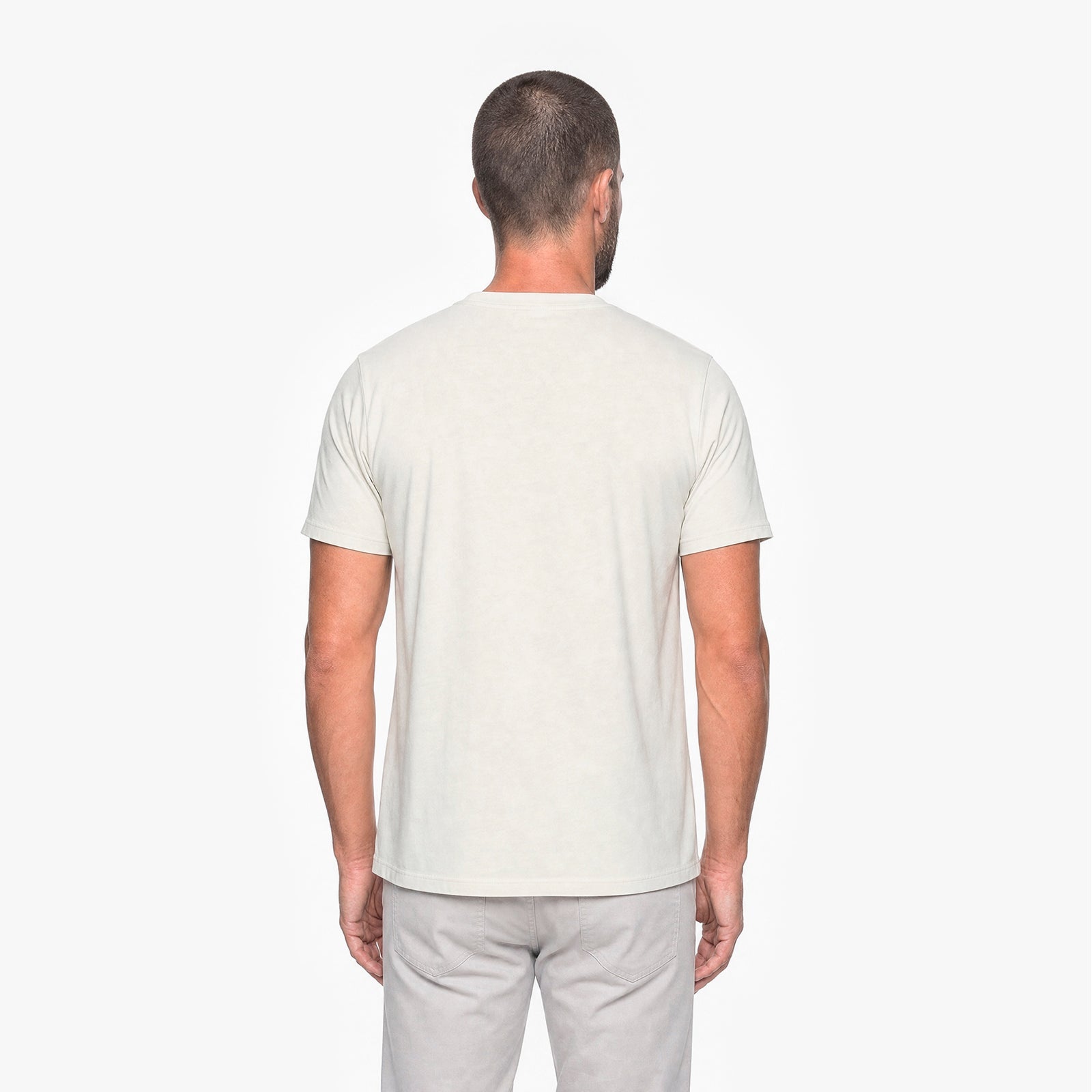 Man wearing a plain white t-shirt on a white background