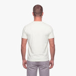 Man wearing a plain white t-shirt on a white background
