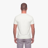 Man wearing a plain white t-shirt on a white background