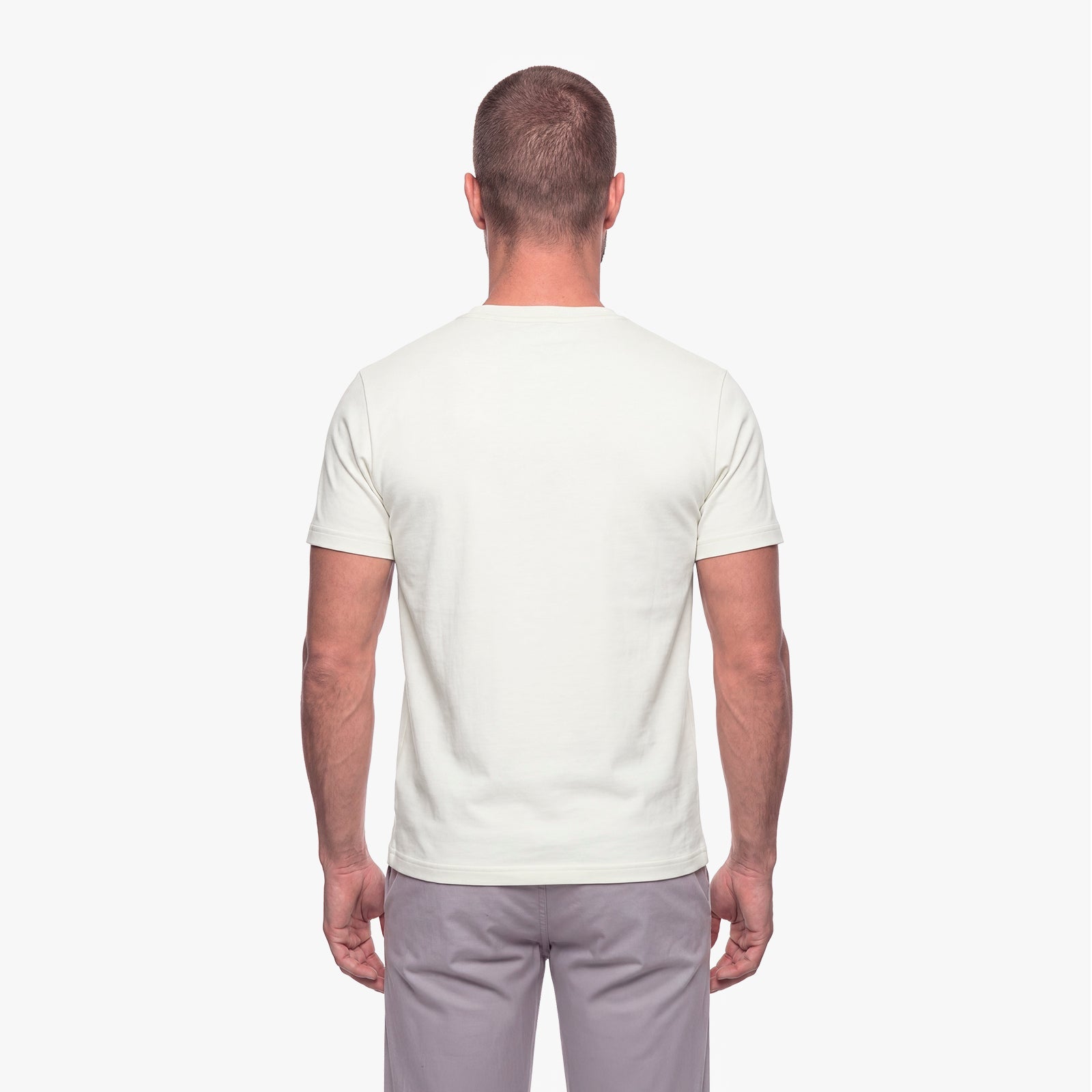 Man wearing a plain white t-shirt on a white background