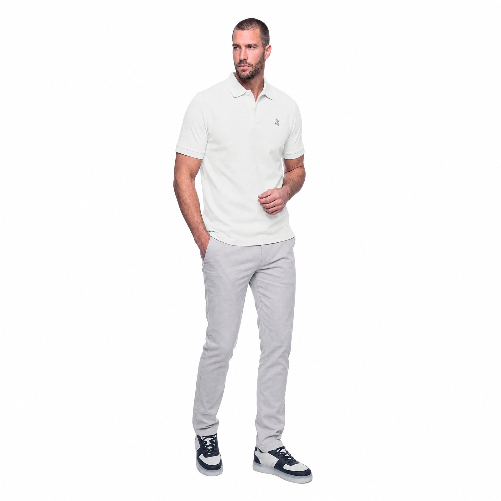 Man wearing a white polo shirt and gray pants on a white background