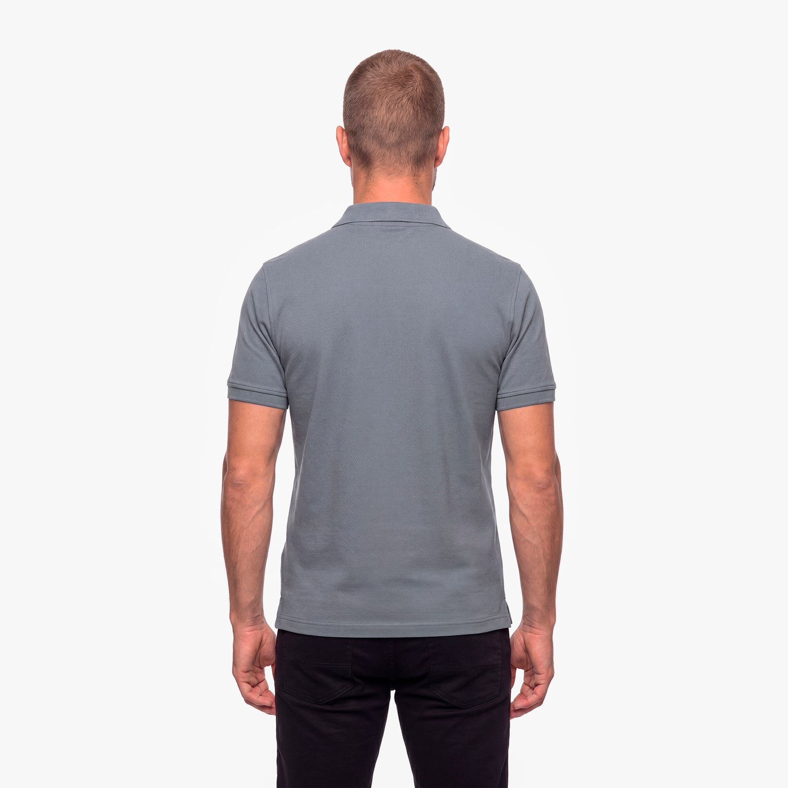 Man wearing a gray polo shirt on a white background