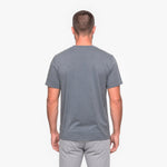 Back view of a man wearing a gray t-shirt on a white background