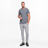 Man wearing a gray t-shirt and pants on a white background
