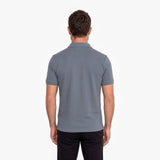 Back view of a man wearing a gray polo