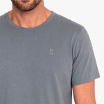 Gray t-shirt with a small logo on a white background