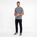 Man wearing a gray t-shirt and black pants on a white background