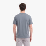 A man viewed from behind wearing a plain gray short-sleeve crewneck t-shirt