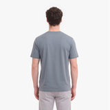 A man viewed from behind wearing a plain gray short-sleeve crewneck t-shirt