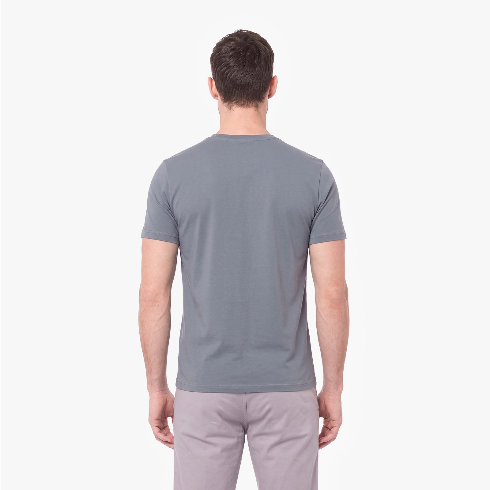 A man viewed from the back wearing a plain gray short-sleeve crewneck t-shirt