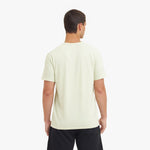 Man wearing a light-colored t-shirt on a white background