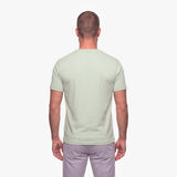 Man wearing a light green t-shirt on a white background