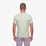 Man wearing a light green t-shirt on a white background