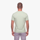 Man wearing a light green t-shirt on a white background