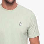 Light green t-shirt with a small logo on a white background
