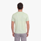 Man wearing a light green t-shirt on a white background