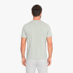Man wearing a light green t-shirt on a white background