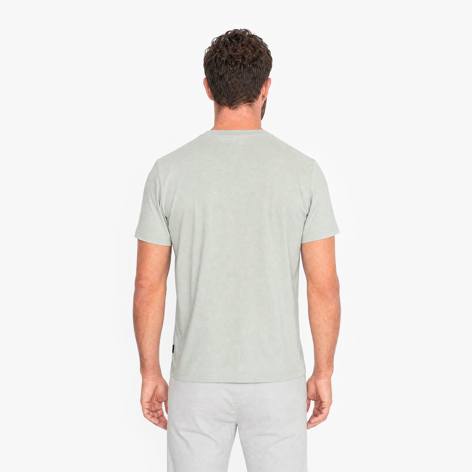 Man wearing a light green t-shirt on a white background