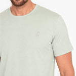 Light green t-shirt with a small logo on a white background
