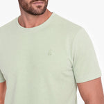 Light green t-shirt with a small logo on a white background