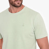 Light green t-shirt with a small logo on a white background
