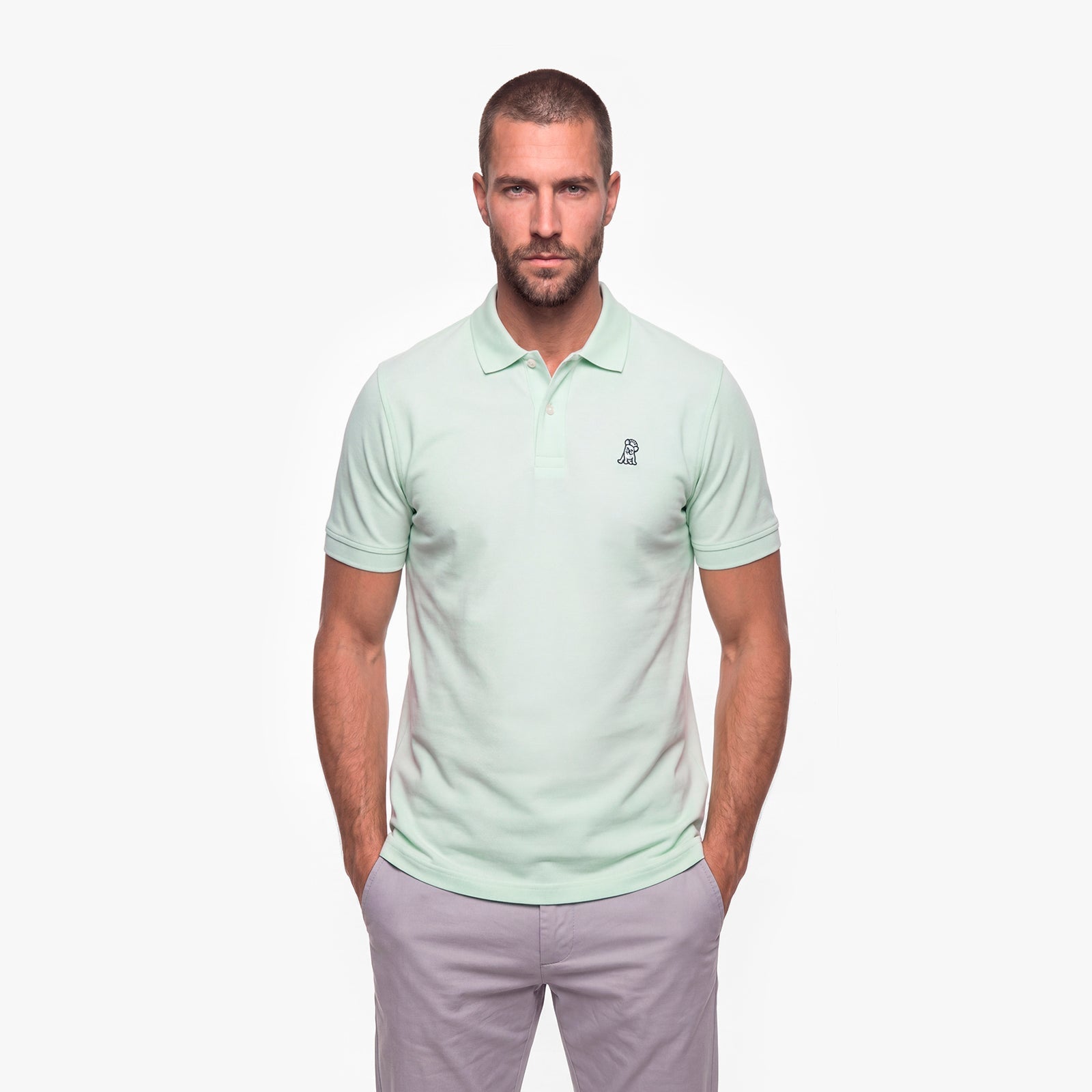 Man wearing a light green polo shirt on a white background