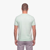 Man wearing a light green t-shirt on a white background