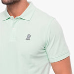 Light green polo shirt with a small logo on a white background