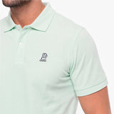 Light green polo shirt with a small logo on a white background