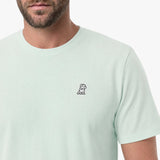 Light green t-shirt with a small logo on a white background