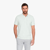 Man wearing a light green polo on a white background