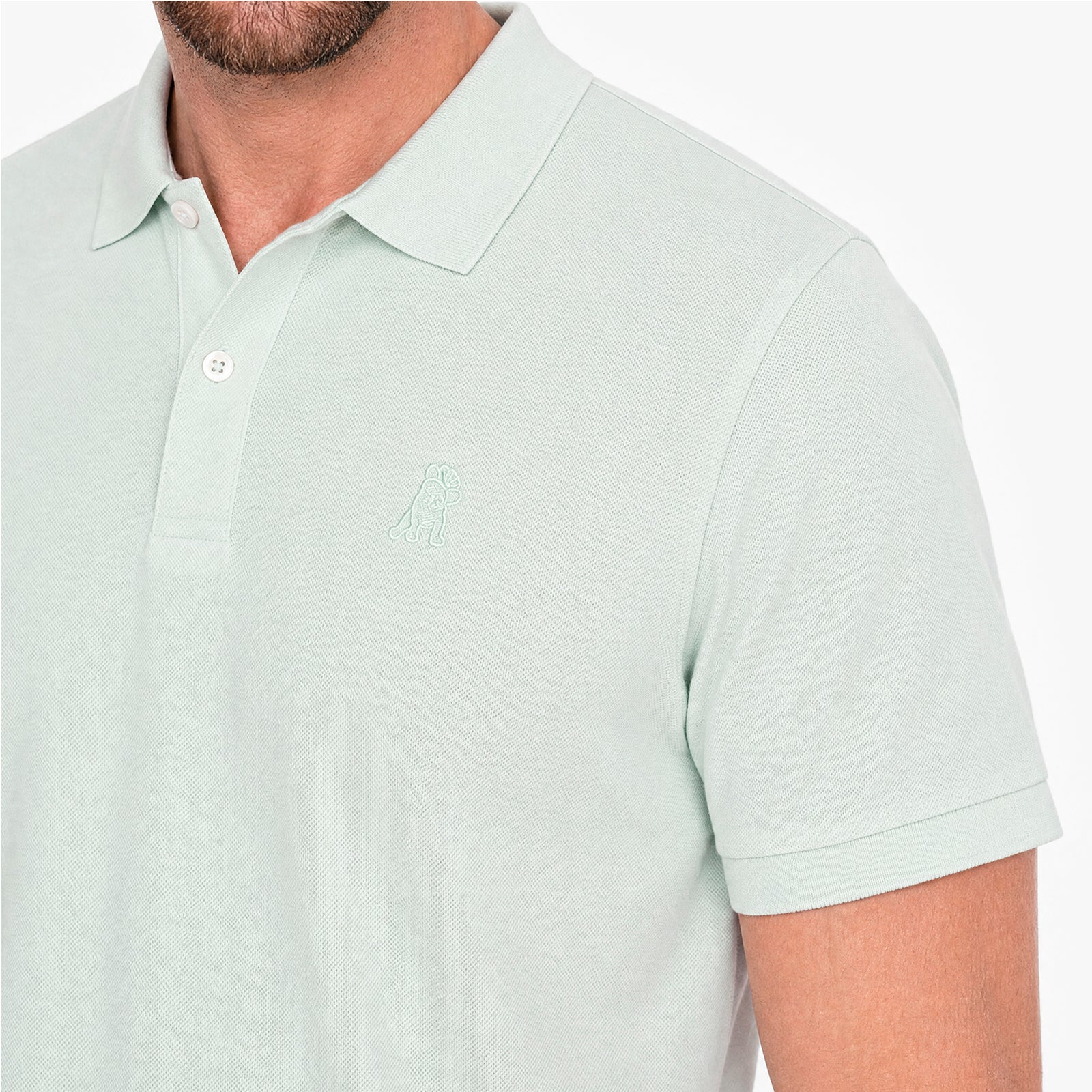 Light green polo shirt with a small logo on a white background