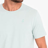 Light green t-shirt with a small green logo on a white background