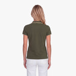 Back view of a woman wearing a green polo with an embroidered dog logo on a white background