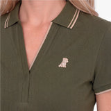 Close-up of a green polo with an embroidered beige dog logo