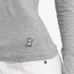 Close-up of a gray long-sleeve shirt with a small logo on the side against a white background