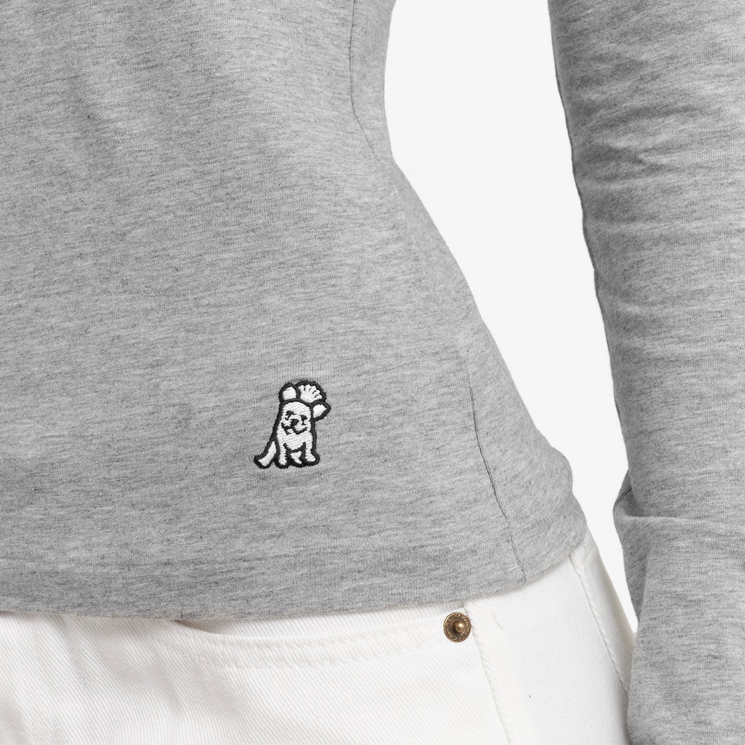 Close-up of a gray long-sleeve shirt with a small logo on the side against a white background