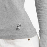 Close-up of a gray long-sleeve shirt with a small logo on the side against a white background