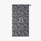 Towel with leaf pattern and JB logo on a white background