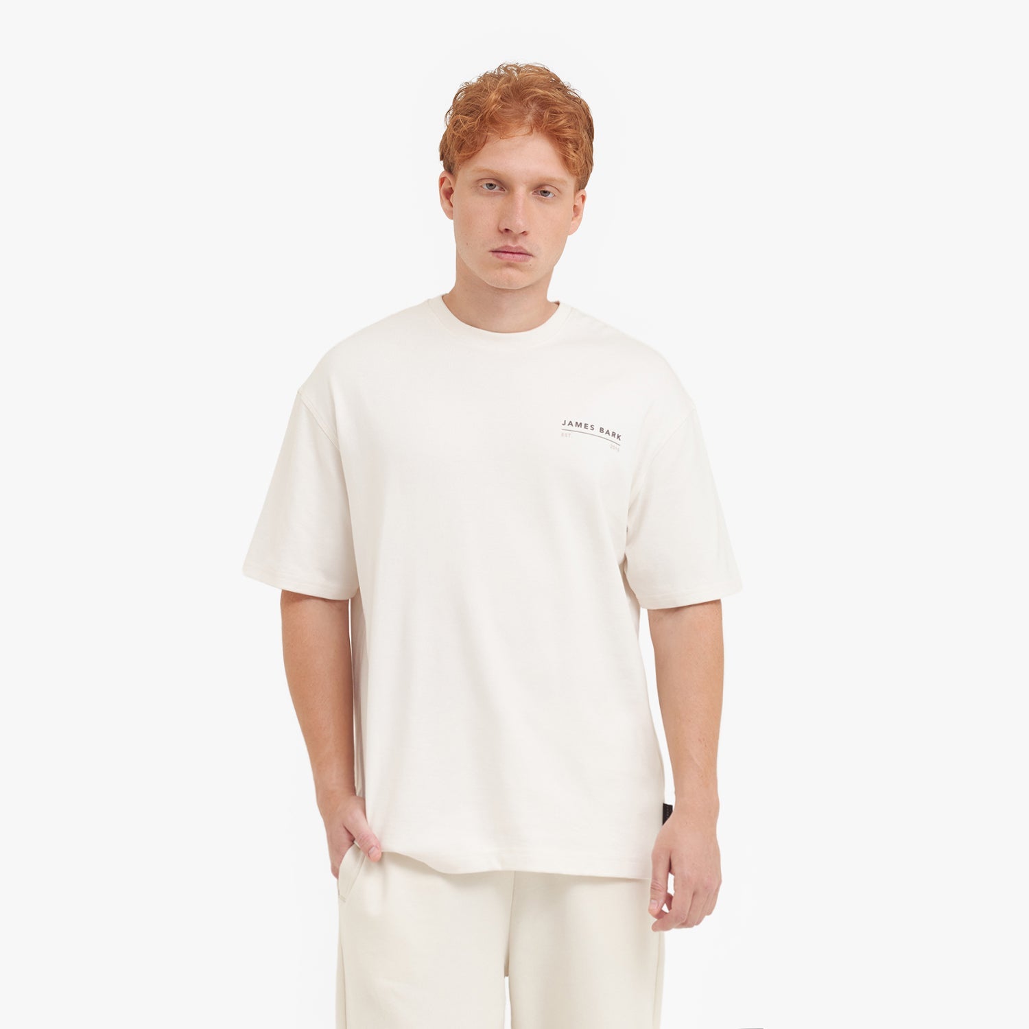 Man wearing a white t-shirt with a logo on a white background
