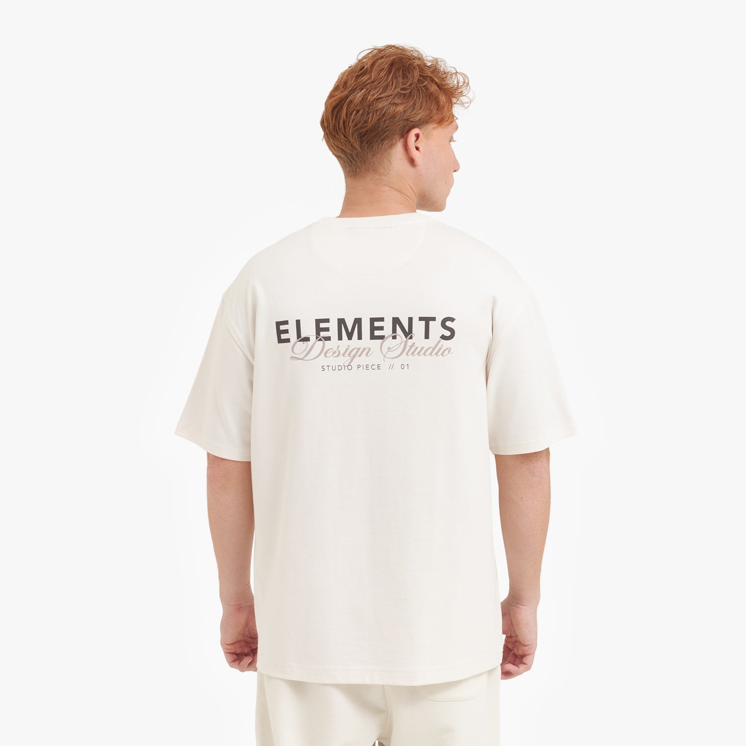 Person wearing a white t-shirt with 'ELEMENTS' branding on the back against a white background