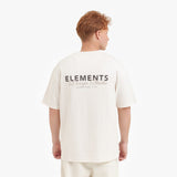 Person wearing a white t-shirt with 'ELEMENTS' branding on the back against a white background