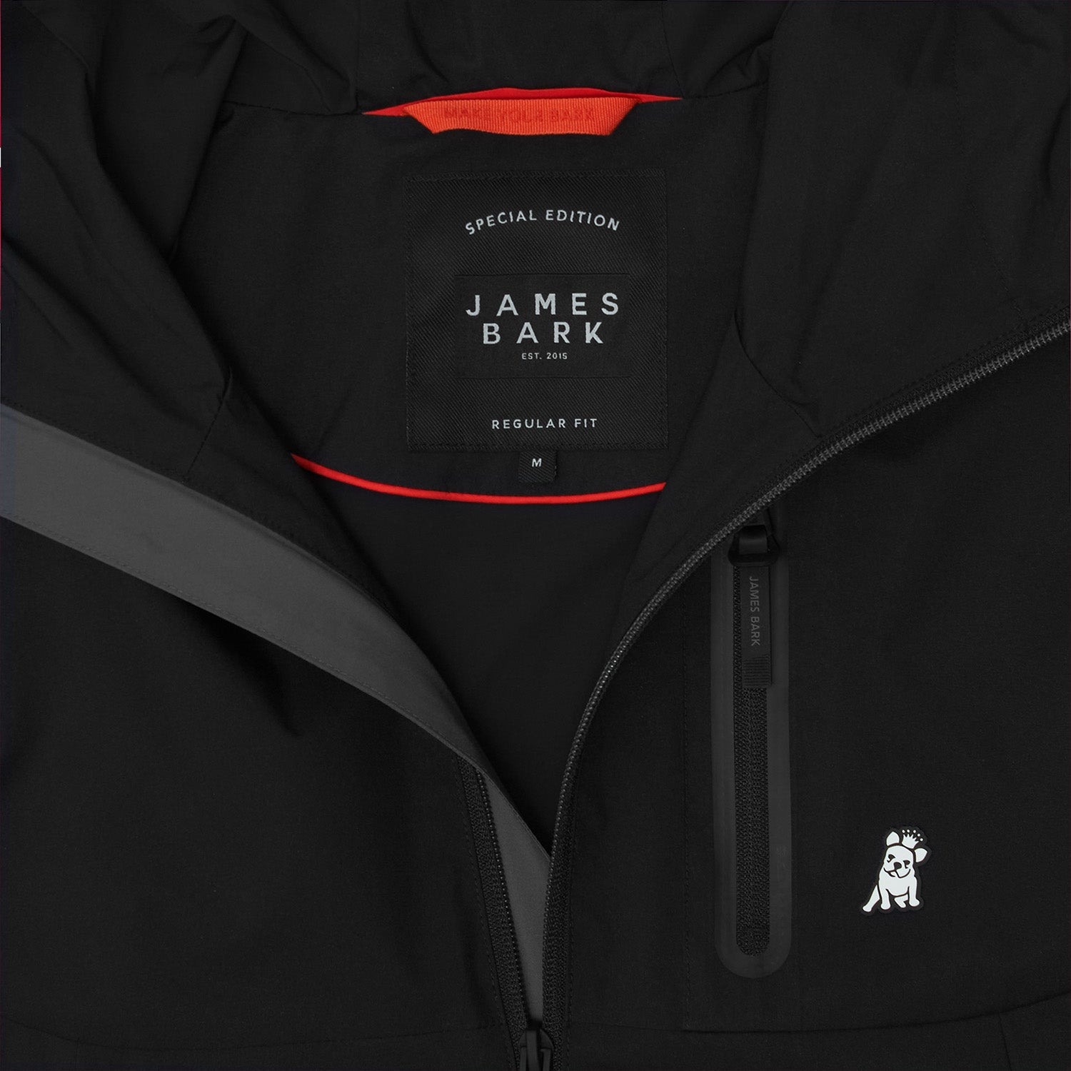 Close-up of the inside of a black jacket. A black label reads "SPECIAL EDITION JAMES BARK". The lining is bright orange.