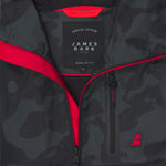 Close-up of the inside of a camouflage-patterned jacket. A black label reads "SPECIAL EDITION JAMES BARK." The lining is bright red.