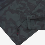 Close-up of the lower pocket and sleeve cuff of a camouflage-patterned jacket. 