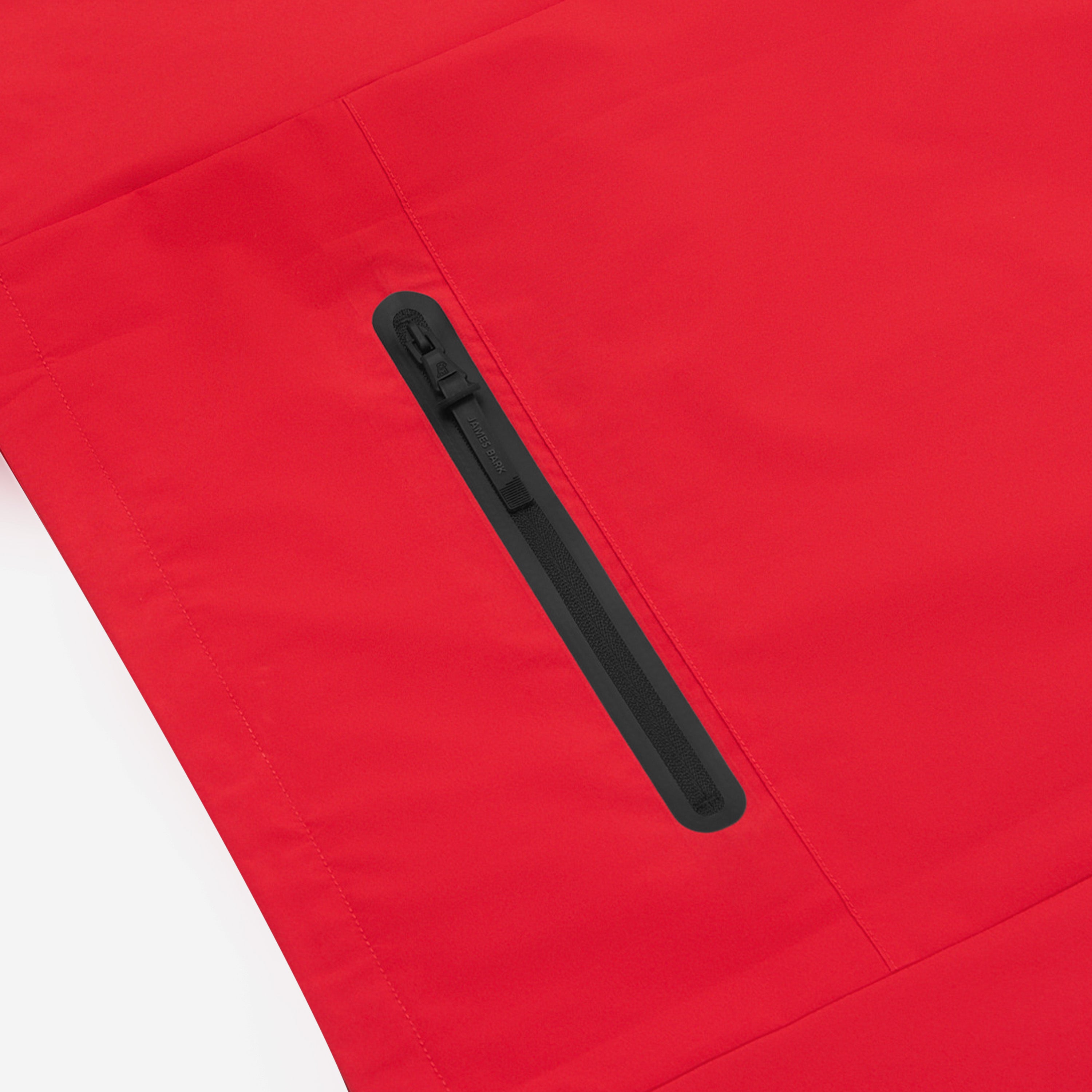 Close-up of the chest pocket of a red jacket. 