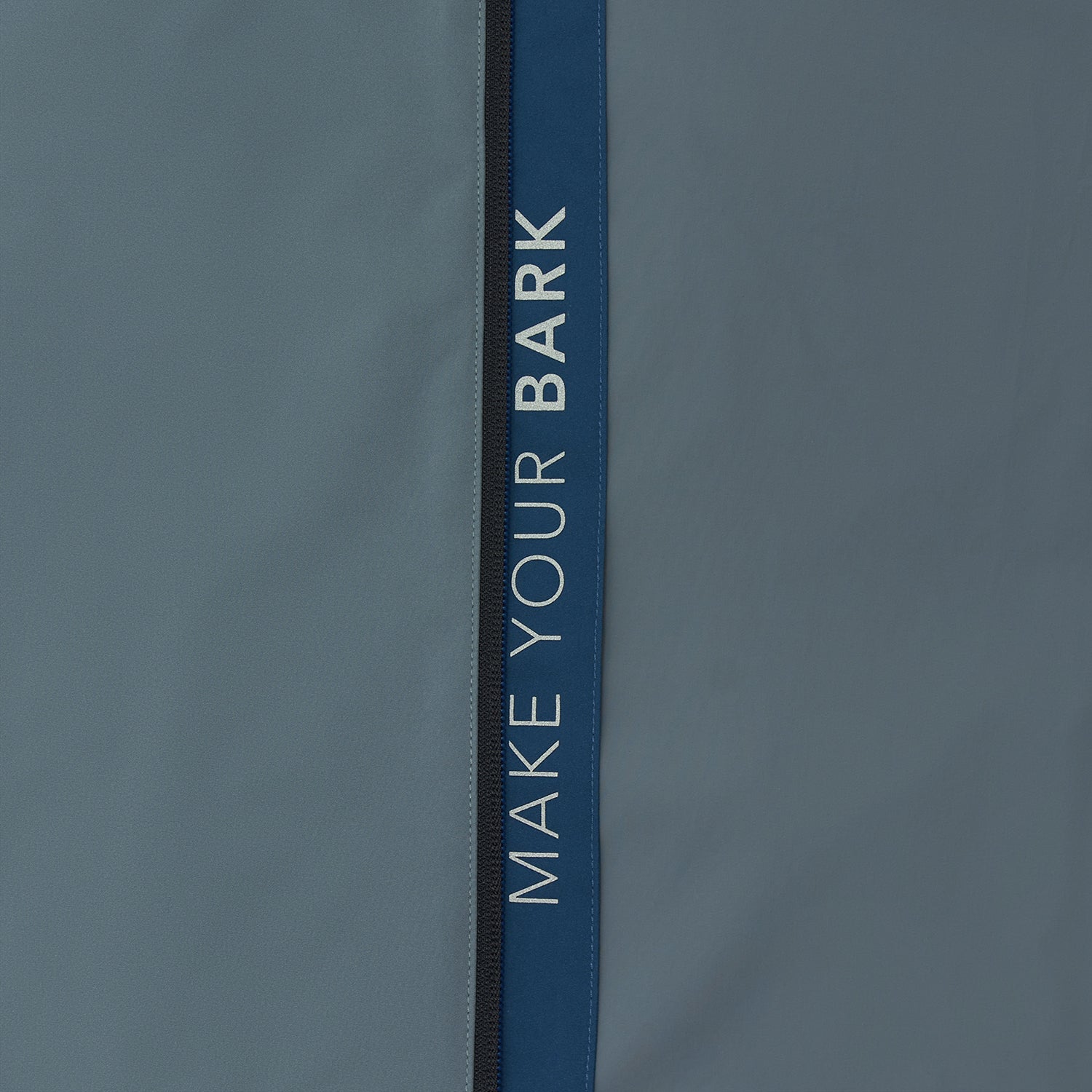 Close-up of the sleeve of a slate blue jacket.