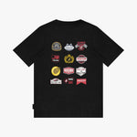 A black short-sleeve t-shirt with a graphic print of twelve racing-themed patches on the front, displayed against a light gray background.